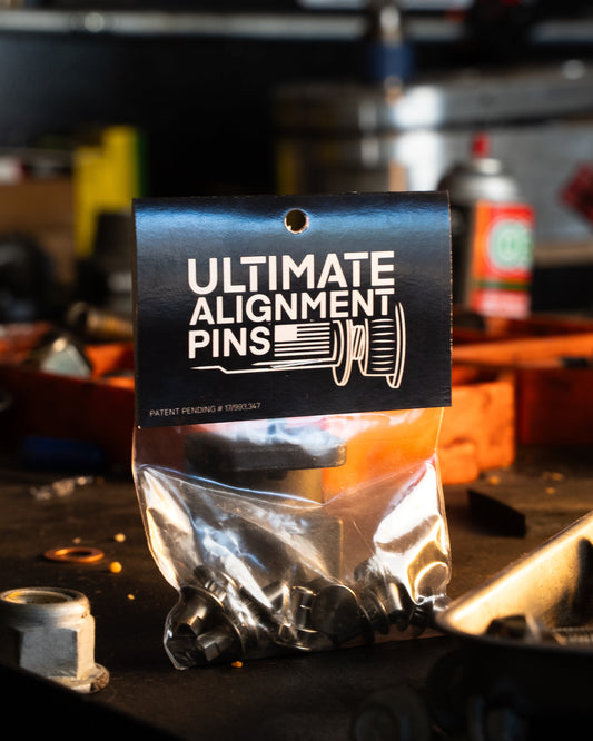 Bag of 'Ultimate Alignment Pins' on a workshop table with tools in the background